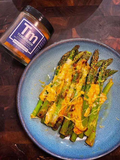 Plated Tomatador & Mozzarella Air Fried Asparagus next to a Spiceology Tomatador jar